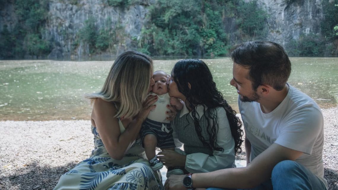 Family enjoying quality time together by the scenic riverside backdrop.