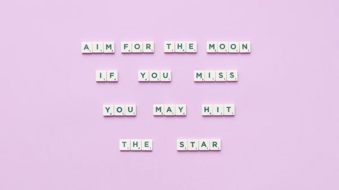 Inspirational message using Scrabble tiles on a pastel background.